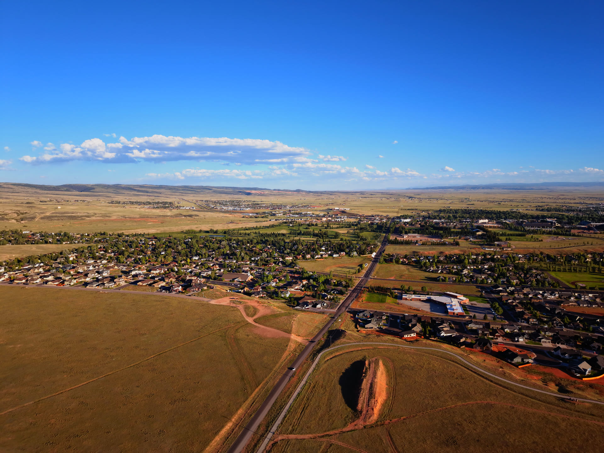 Aerial drone still of Wyoming acreage and open land near Laramie at golden hour