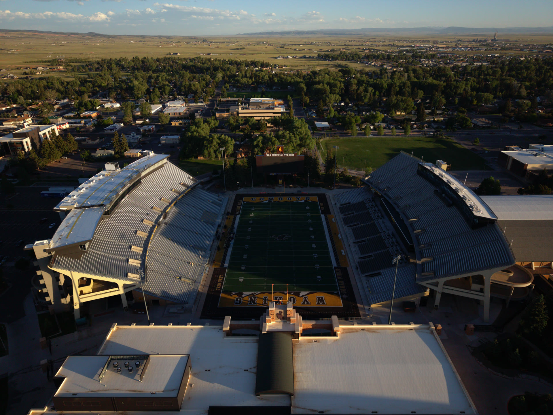 Golden-hour aerial drone still of War Memorial Stadium in Laramie